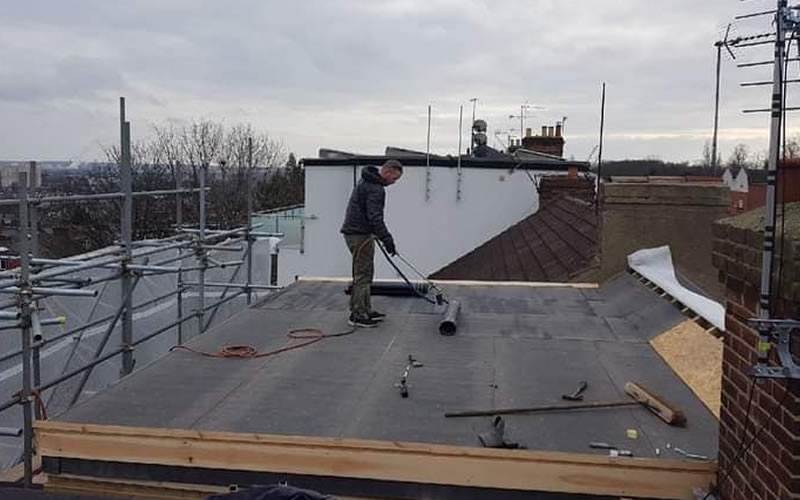 Flat roof repair and maintenance work in progress
