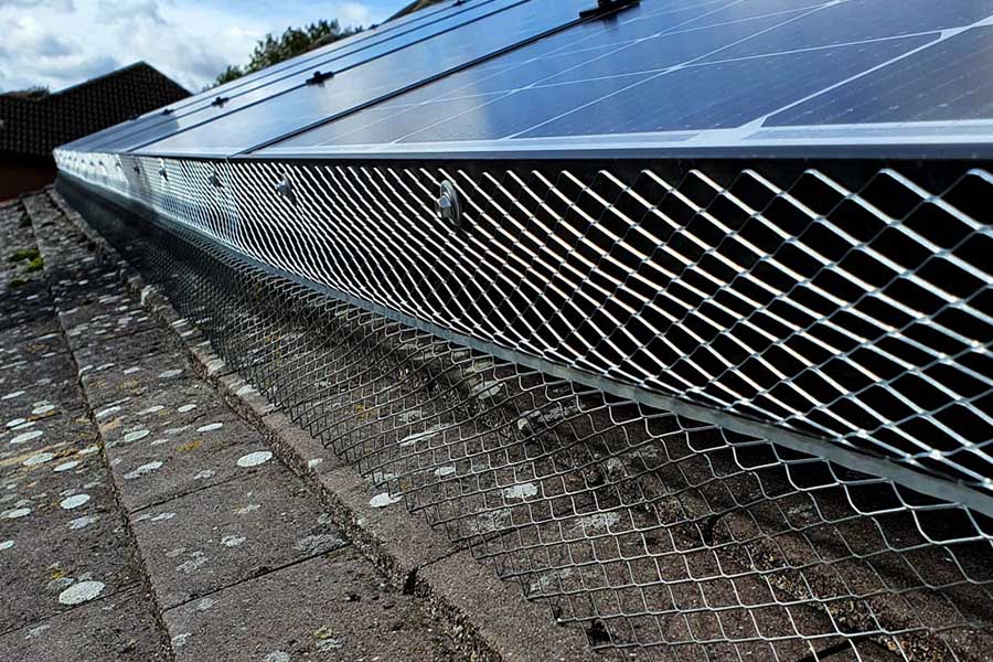 Bird proofing mesh being installed under solar panels