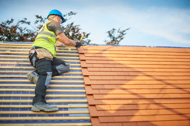 Roofer installing roof tiles on a residential house